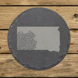South Dakota round slate coaster engraved with the state shape in ornate floral scrollwork