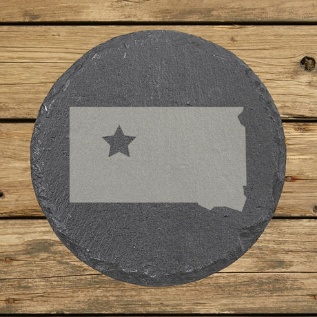 South Dakota round slate coaster engraved with the state shape and a star