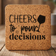Square cork coaster laser engraved with "Cheers to Pour Decisions"
