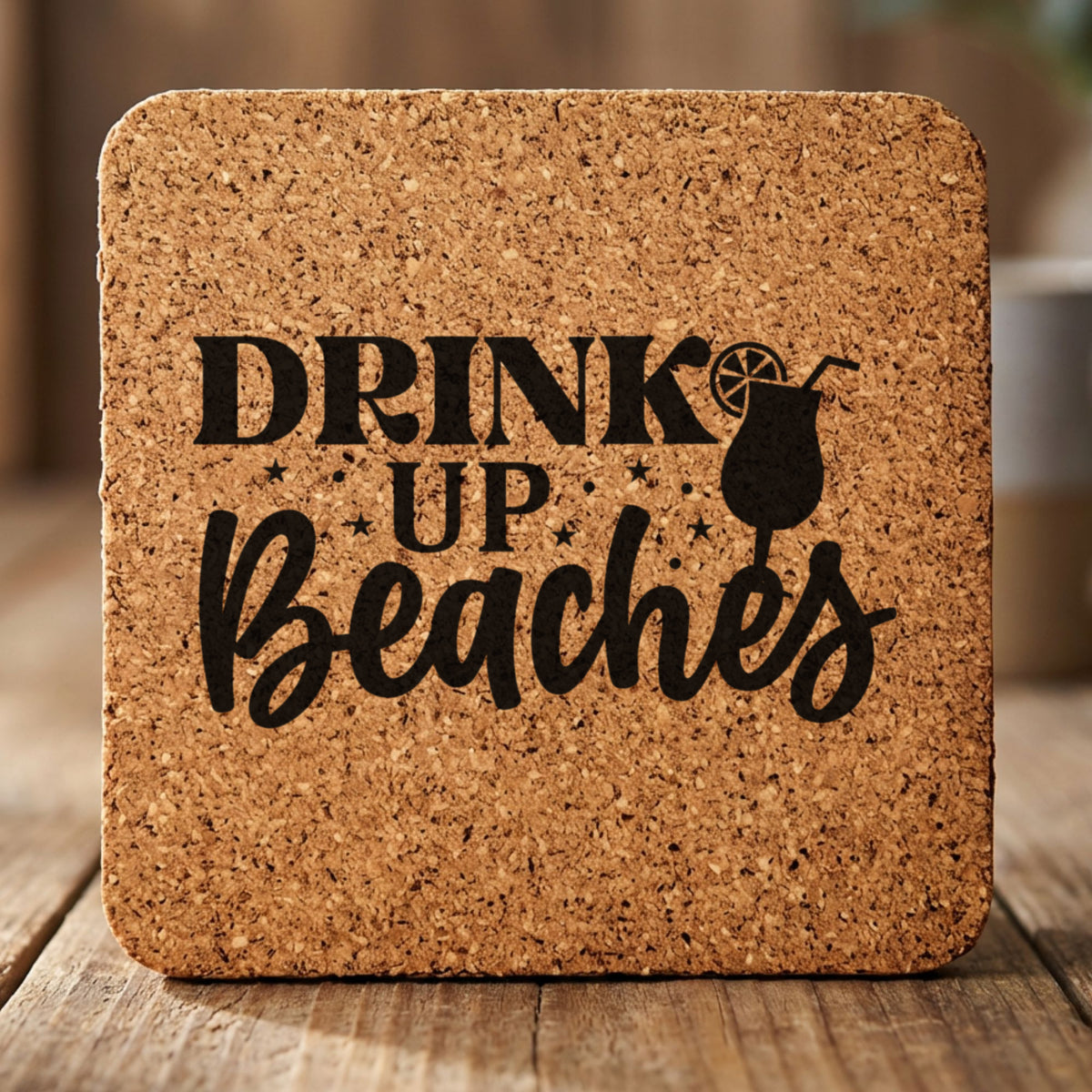 Square cork coaster laser engraved with "Drink Up Beaches"