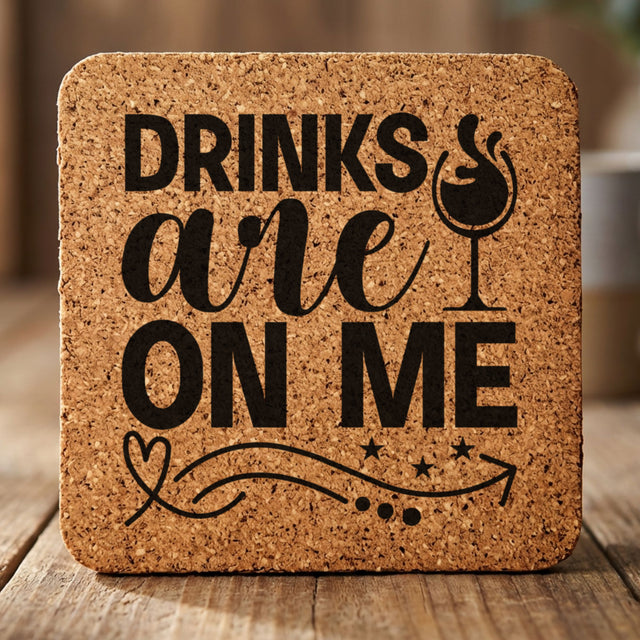 Square cork coaster laser engraved with "Drinks Are On Me", wine glass design
