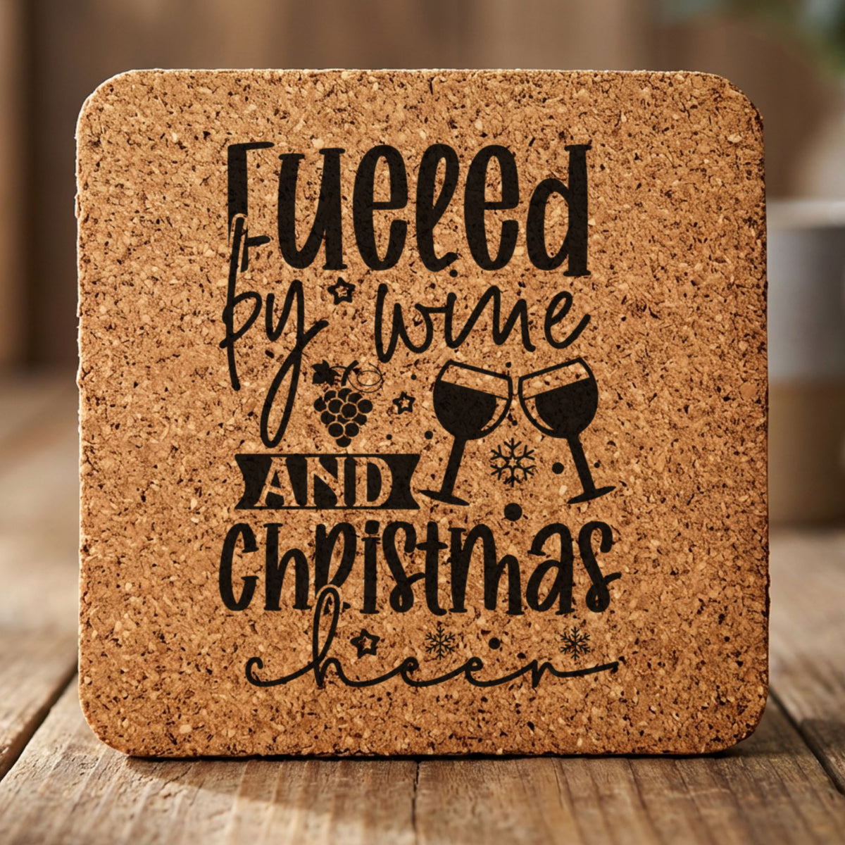 Square cork coaster laser engraved with "Fueled by Wine and Christmas Cheer"