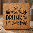 Square cork coaster laser engraved with "Merry Drunk I'm Christmas"