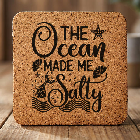 Square cork coaster laser engraved with "The Ocean Made Me Salty"