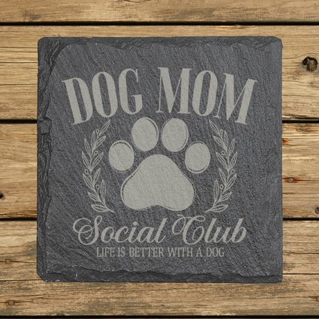 Square slate coaster laser engraved with a Dog Mom Social Club crest design with a paw print and laurel wreath