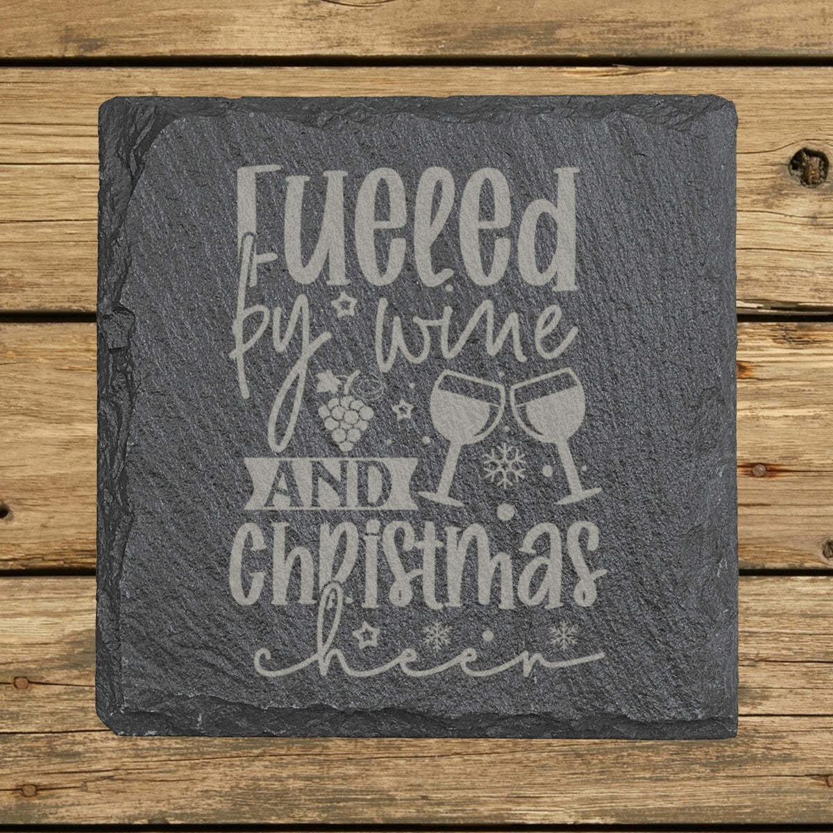 Square slate coaster laser engraved with "Fueled by Wine and Christmas Cheer"
