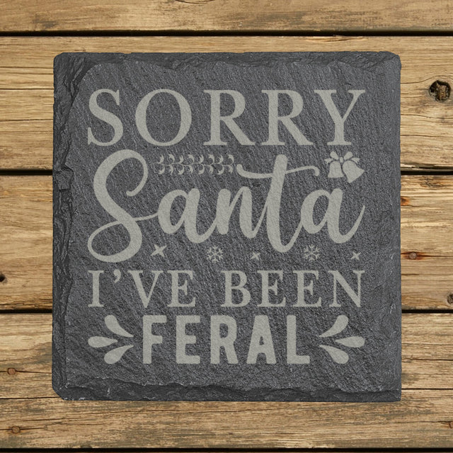 Square slate coaster laser engraved with "Sorry Santa, I've Been Feral"