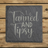 Square slate coaster laser engraved with "Tanned and Tipsy"