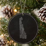 Black leatherette round Christmas ornament laser engraved with the Delaware Word Cloud design, hanging on a tree