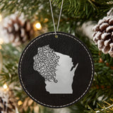 Black leatherette round Christmas ornament laser engraved with the Wisconsin Floral Damask design, hanging on a tree