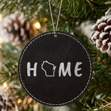 Black leatherette round Christmas ornament laser engraved with the Wisconsin HOME Outline design, hanging on a tree