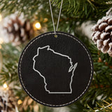 Black leatherette round Christmas ornament laser engraved with the Wisconsin Classic Outline design, hanging on a tree