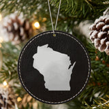 Black leatherette round Christmas ornament laser engraved with the Wisconsin Engraved State design, hanging on a tree