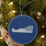 Blue leatherette round Christmas ornament laser engraved with the Delaware Floral Damask design, hanging on a tree