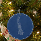Blue leatherette round Christmas ornament laser engraved with the Delaware Word Cloud design, hanging on a tree