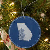 Blue leatherette round Christmas ornament laser engraved with the Georgia Floral Damask design, hanging on a tree