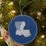 Blue leatherette round Christmas ornament laser engraved with the Louisiana Floral Damask design, hanging on a tree