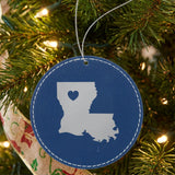 Blue leatherette round Christmas ornament laser engraved with the Louisiana Heart Accent design, hanging on a tree