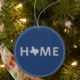Blue leatherette round Christmas ornament laser engraved with the Texas HOME Outline design, hanging on a tree
