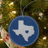 Blue leatherette round Christmas ornament laser engraved with the Texas Heart Accent design, hanging on a tree