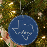 Blue leatherette round Christmas ornament laser engraved with the Texas Hand-Drawn Love design, hanging on a tree