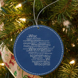 Blue leatherette round Christmas ornament laser engraved with the Wisconsin Word Cloud design, hanging on a tree