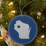 Blue leatherette round Christmas ornament laser engraved with the Wisconsin Star Accent design, hanging on a tree