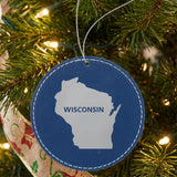 Blue leatherette round Christmas ornament laser engraved with the Wisconsin Bold State Name design, hanging on a tree