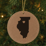 Brown leatherette round Christmas ornament laser engraved with the Illinois Heart Accent design, hanging on a tree