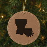 Brown leatherette round Christmas ornament laser engraved with the Louisiana Engraved State design, hanging on a tree