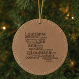 Brown leatherette round Christmas ornament laser engraved with the Louisiana Word Cloud design, hanging on a tree