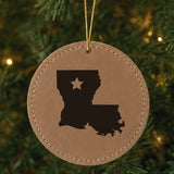 Brown leatherette round Christmas ornament laser engraved with the Louisiana Star Accent design, hanging on a tree