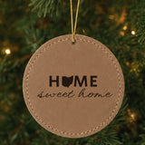 Brown leatherette round Christmas ornament laser engraved with the Ohio Home Sweet Home design, hanging on a tree