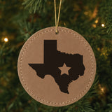 Brown leatherette round Christmas ornament laser engraved with the Texas Star Accent design, hanging on a tree