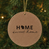 Brown leatherette round Christmas ornament laser engraved with the Wisconsin Home Sweet Home design, hanging on a tree