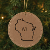 Brown leatherette round Christmas ornament laser engraved with the Wisconsin WI Initials design, hanging on a tree