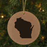 Brown leatherette round Christmas ornament laser engraved with the Wisconsin Engraved State design, hanging on a tree