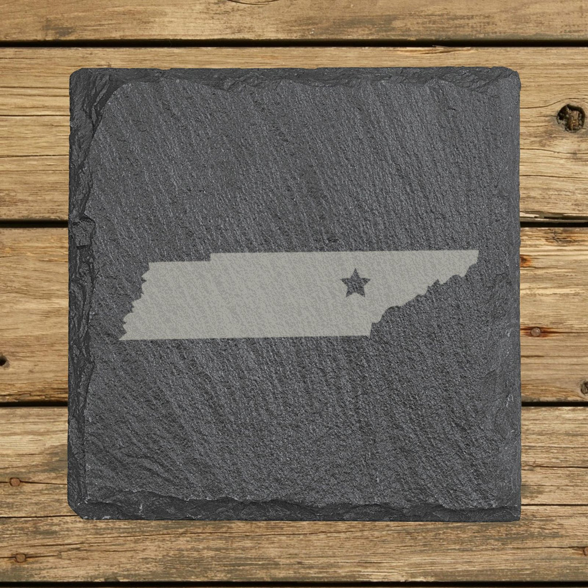 Tennessee square slate coaster engraved with the state shape and a star