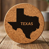 Texas round cork coaster engraved with the state shape and TEXAS in bold lettering