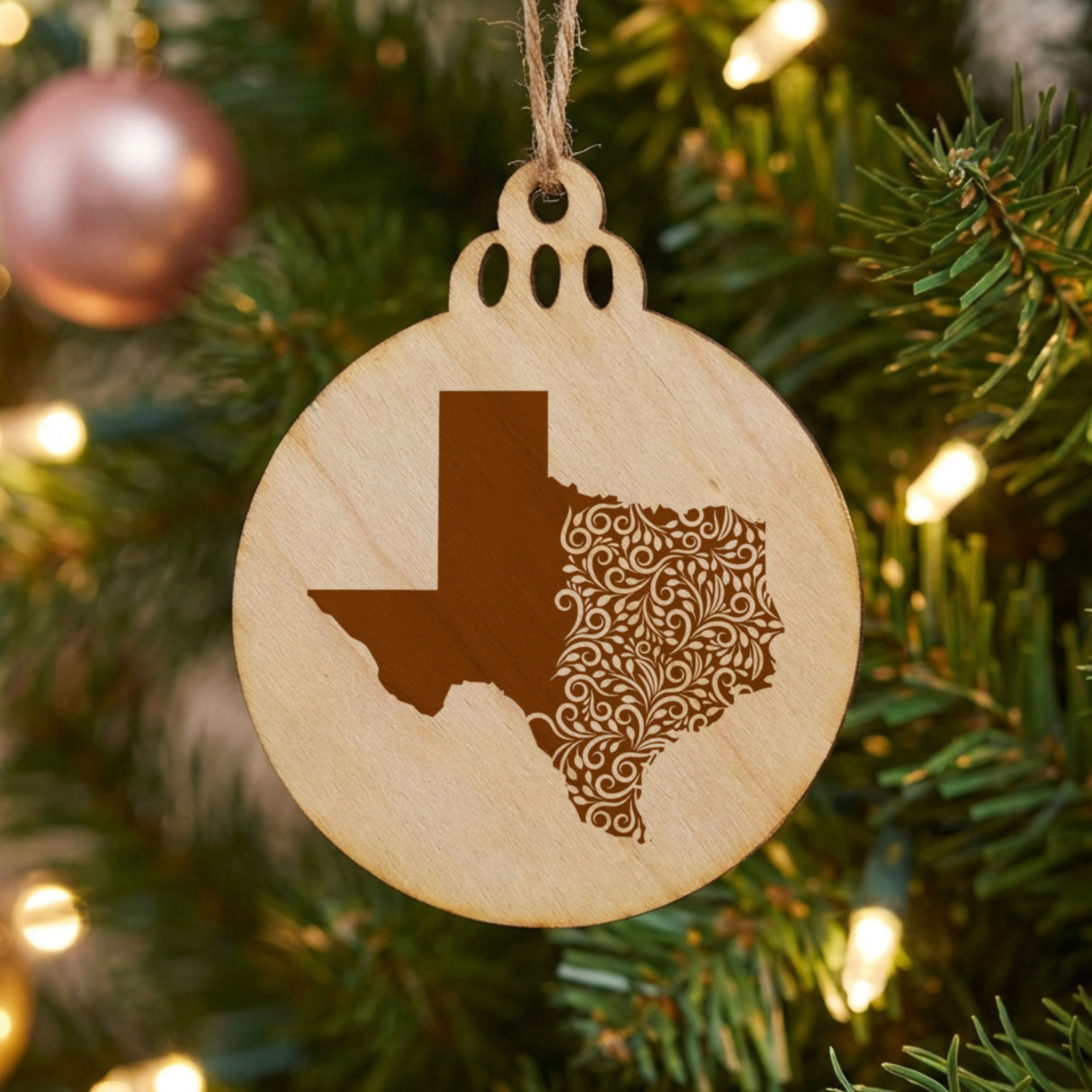 Texas round wood Christmas ornament engraved with the state shape in ornate floral scrollwork