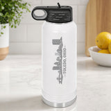 White 32 oz insulated water bottle laser engraved with the Toledo, Ohio skyline running up the side, standing on a kitchen counter