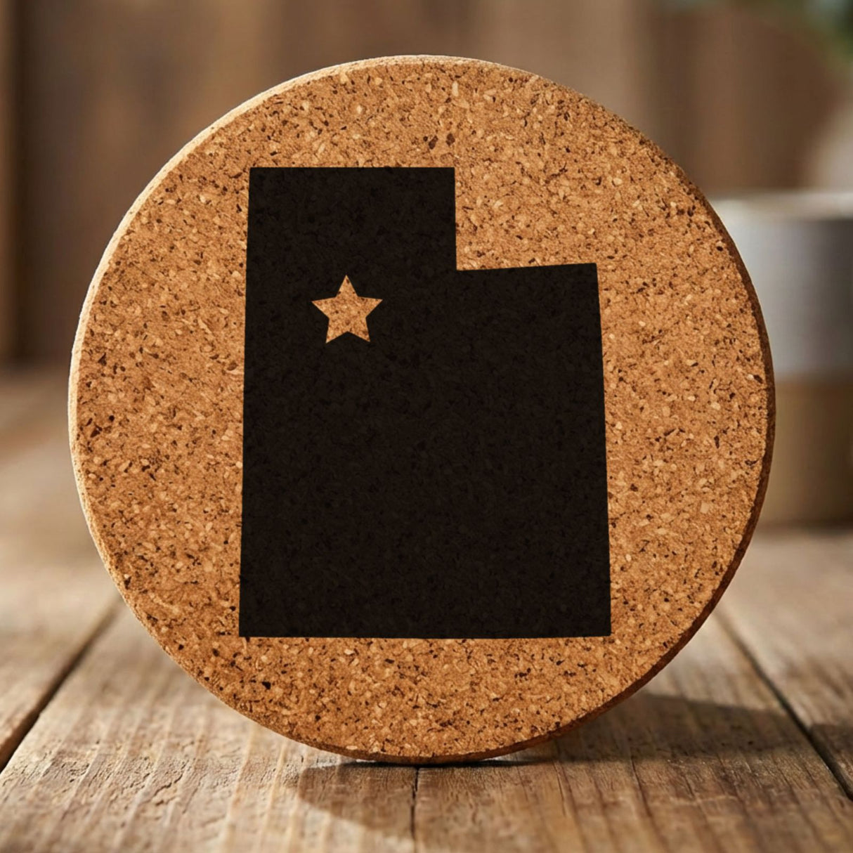 Utah round cork coaster engraved with the state shape and a star