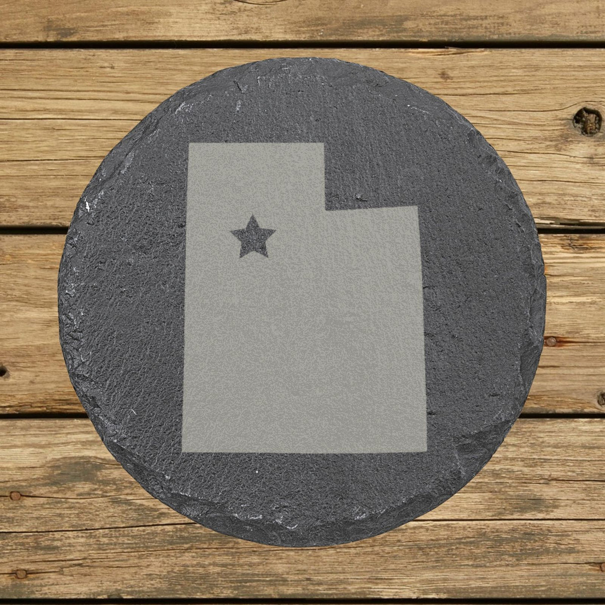 Utah round slate coaster engraved with the state shape and a star
