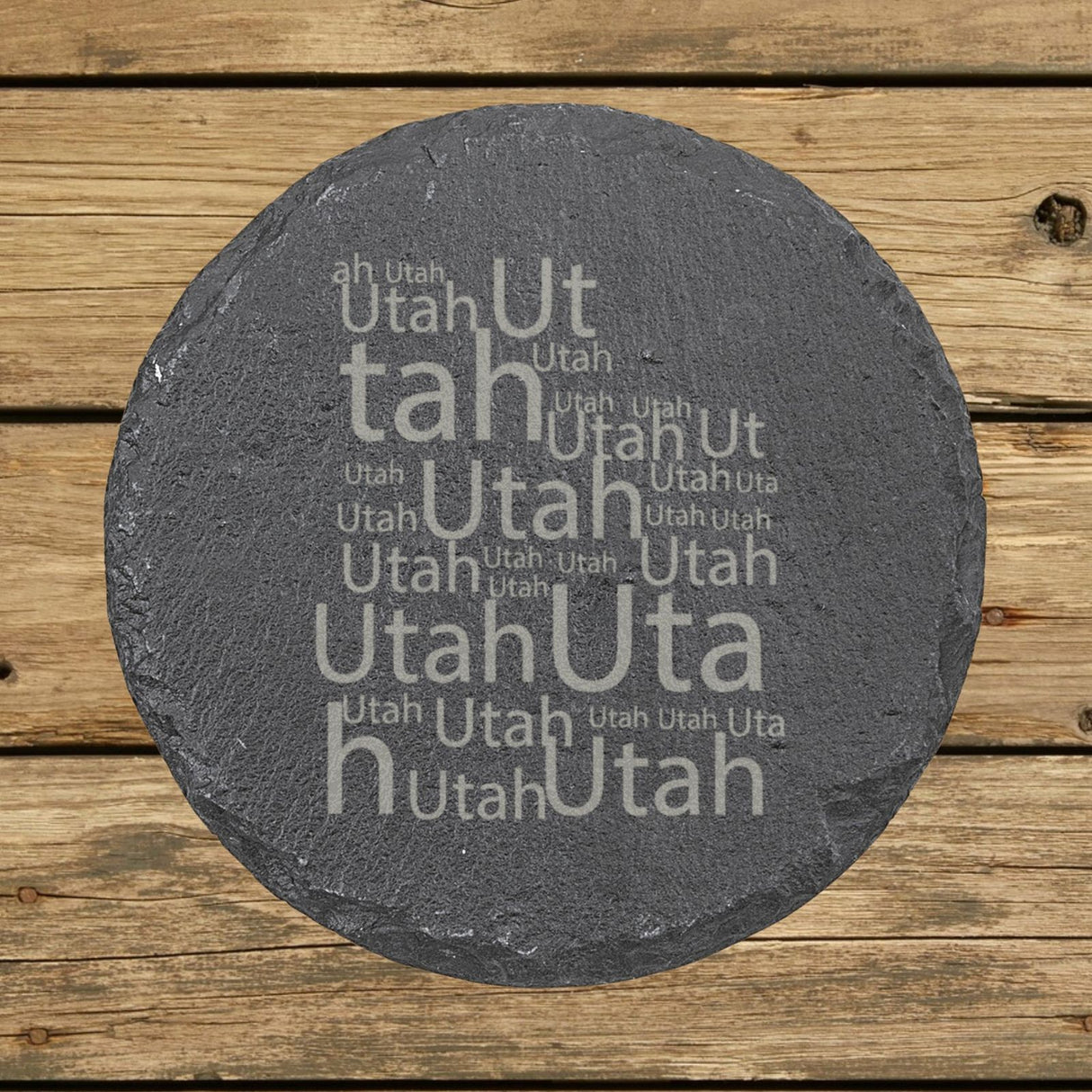 Utah round slate coaster engraved with a word cloud of repeating Utah text