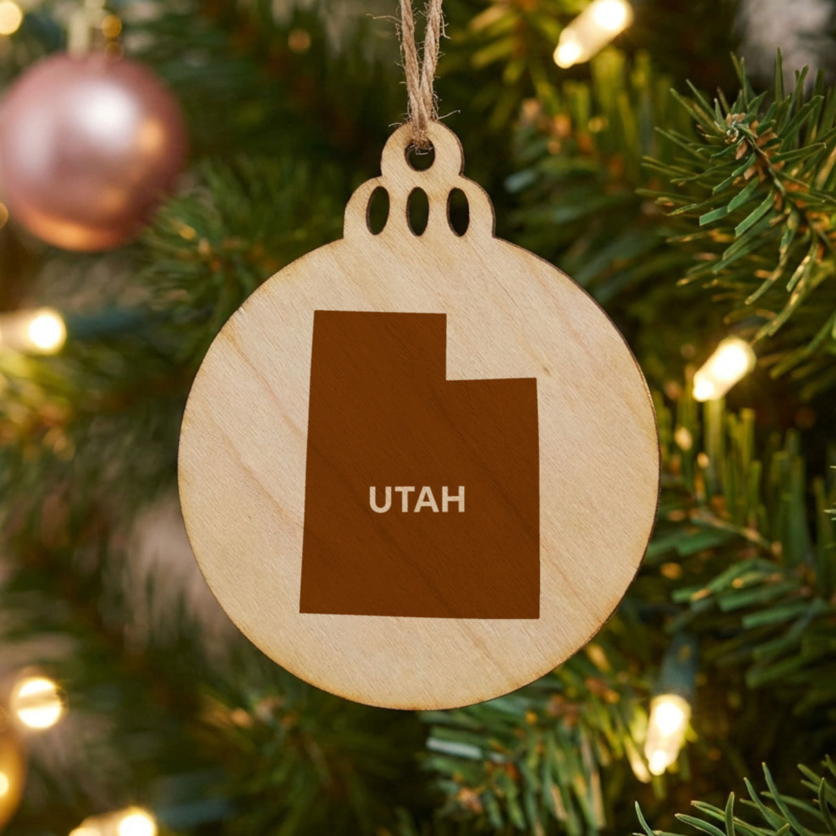 Utah round wood Christmas ornament engraved with the state shape and UTAH in bold lettering