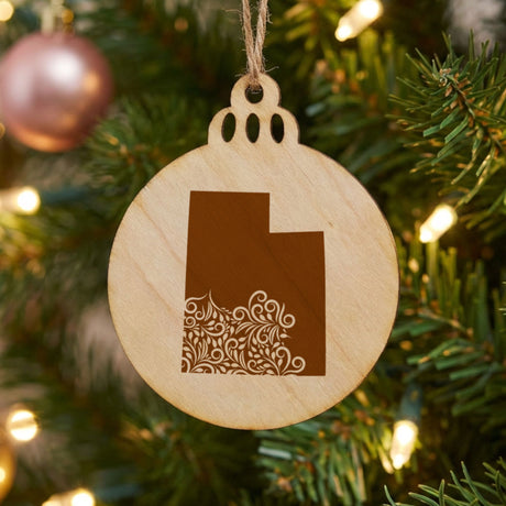 Utah round wood Christmas ornament engraved with the state shape in ornate floral scrollwork
