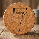Vermont round cork coaster engraved with the state outline and VERMONT in hand-drawn brush lettering