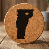Vermont round cork coaster engraved with the state shape and a heart