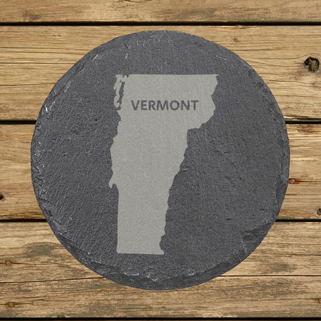 Vermont round slate coaster engraved with the state shape and VERMONT in bold lettering