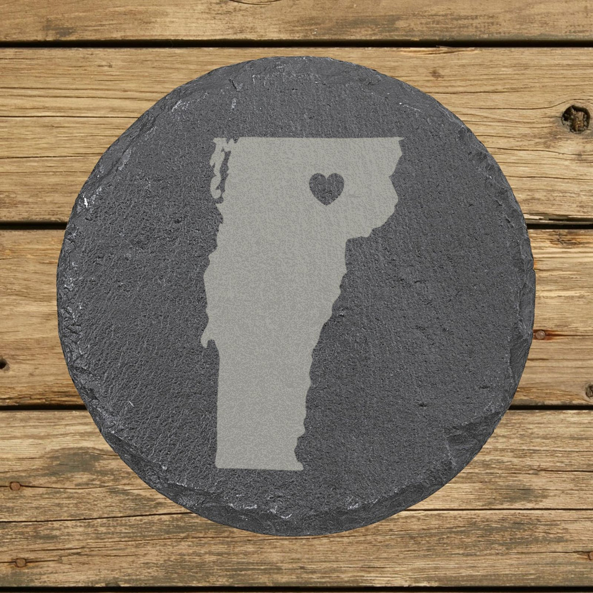 Vermont round slate coaster engraved with the state shape and a heart